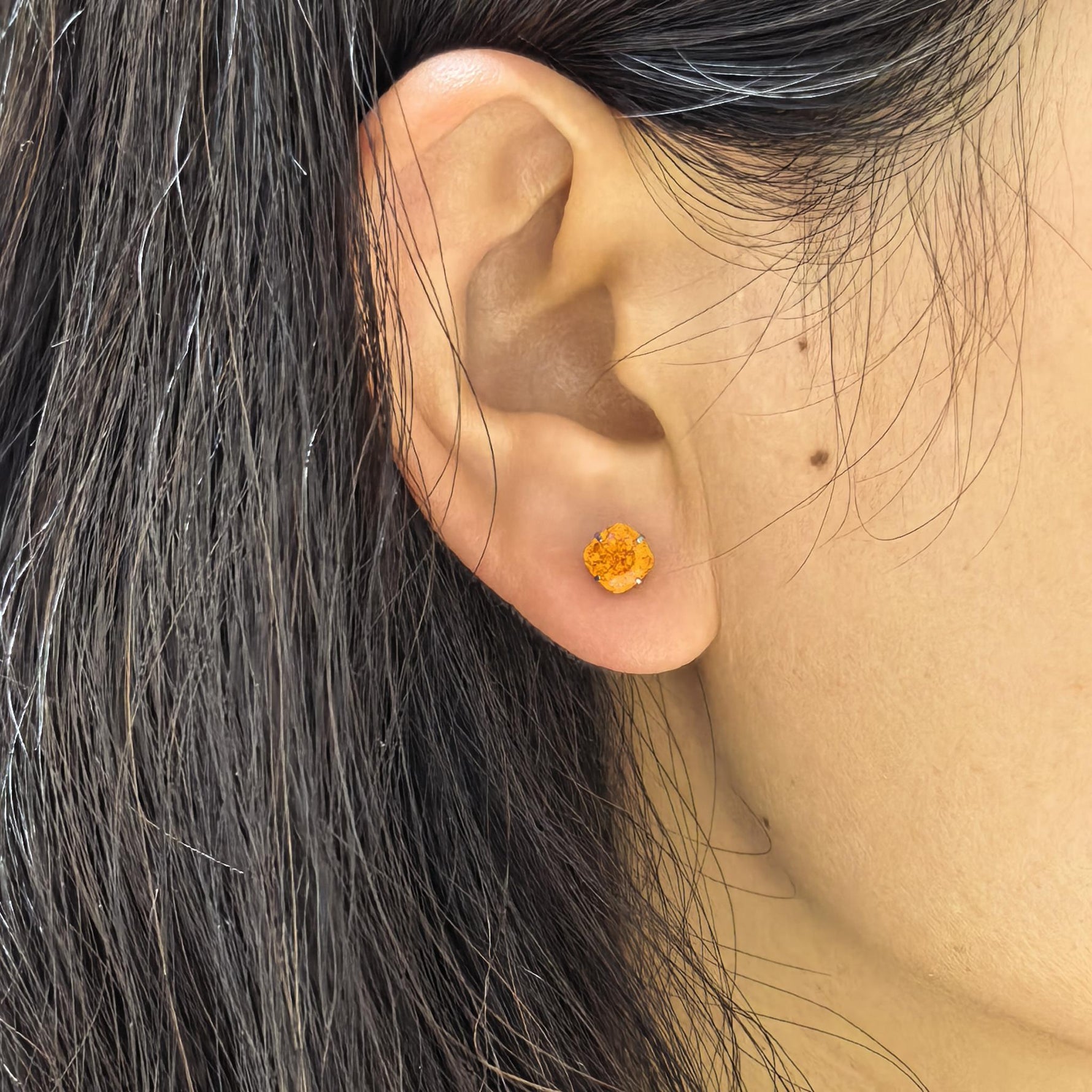 Close‑up wearing shot for 6mm fat‑square‑bouquet cut cubic zirconia cartilage stud, nickel‑free titanium screw‑back