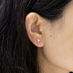 Ear close‑up view, 4 mm starburst faceted cubic zirconia cartilage stud earring, hypoallergenic titanium steel screw back ear jewellery