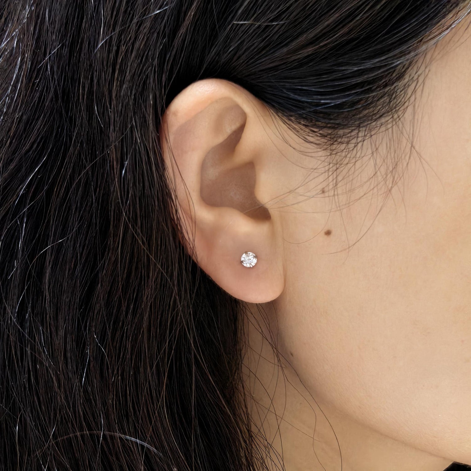 Ear close‑up view, 4 mm starburst faceted cubic zirconia cartilage stud earring, hypoallergenic titanium steel screw back ear jewellery