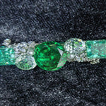 close‑up view of faceted emerald and paraiba cubic zirconia one‑of‑a‑kind handmade hair clip